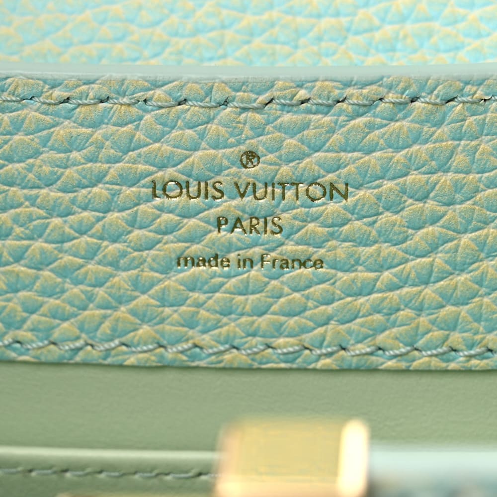 image of an authentic louis vuitton interior logo stamp on a capucines bag by FASHIONPHILE