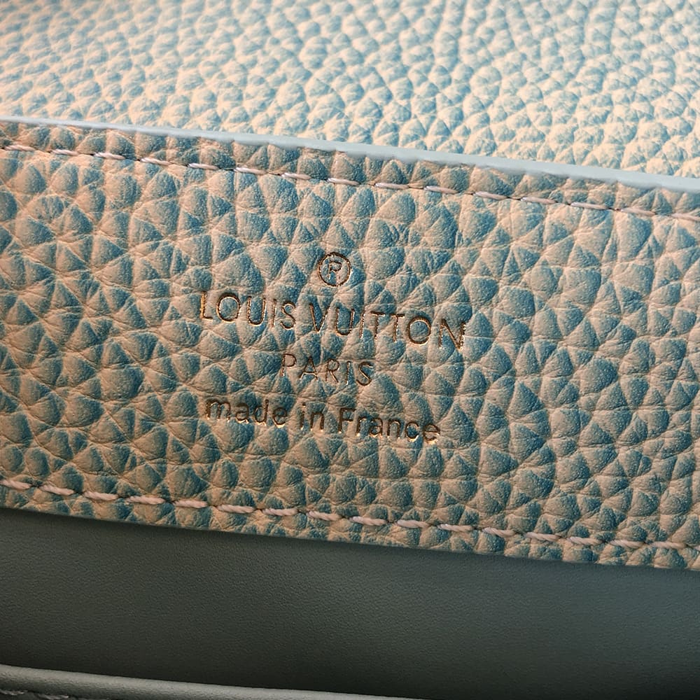 image of a fake louis vuitton interior logo stamp on a capucines bag by FASHIONPHILE