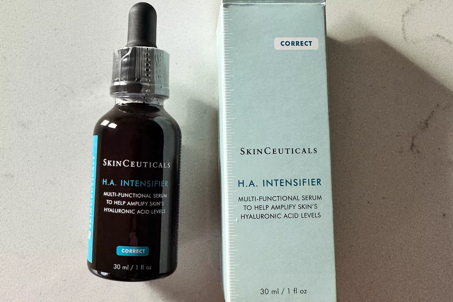 A bottle of SkinCeuticals Hyaluronic Acid Intensifier (H.A.) next to its box